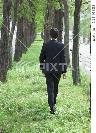 人物 男性 歩く 後ろ姿の写真素材