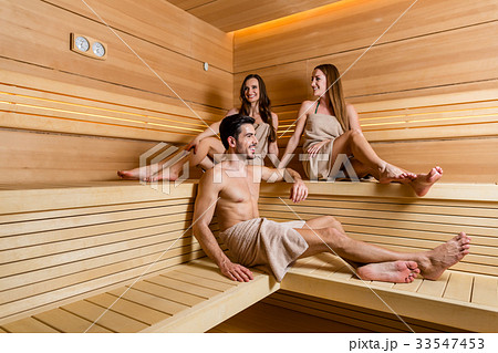 Three diverse young women in underwear holding hands and laughing