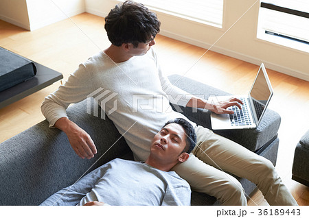 Men Relaxing In The Living Room Stock Photo