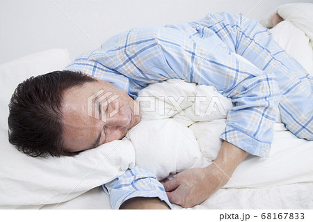 寝相が悪いミドル男性の写真素材