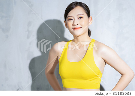 slim athletic woman working out with battle rope in gym. fitness