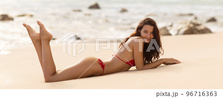 Beautiful Asian fit bikini body model relaxing on Caribbean beach