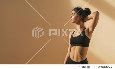 African American girl in gym outfit, holding a yoga mat. Beautiful